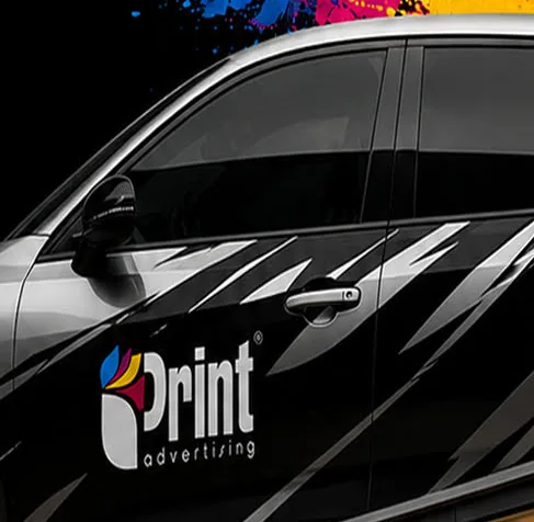 Close-up of a black vehicle carrying iPrint advertising graphics and vinyl decals.