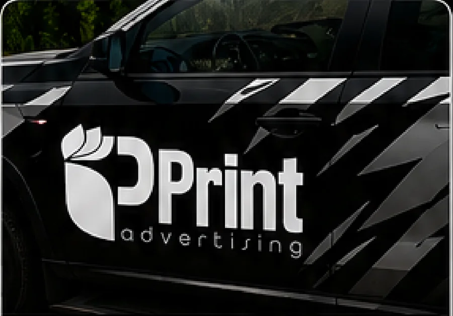 Black car with an iPrint advertising logo and geometric vinyl decal graphics along the door.